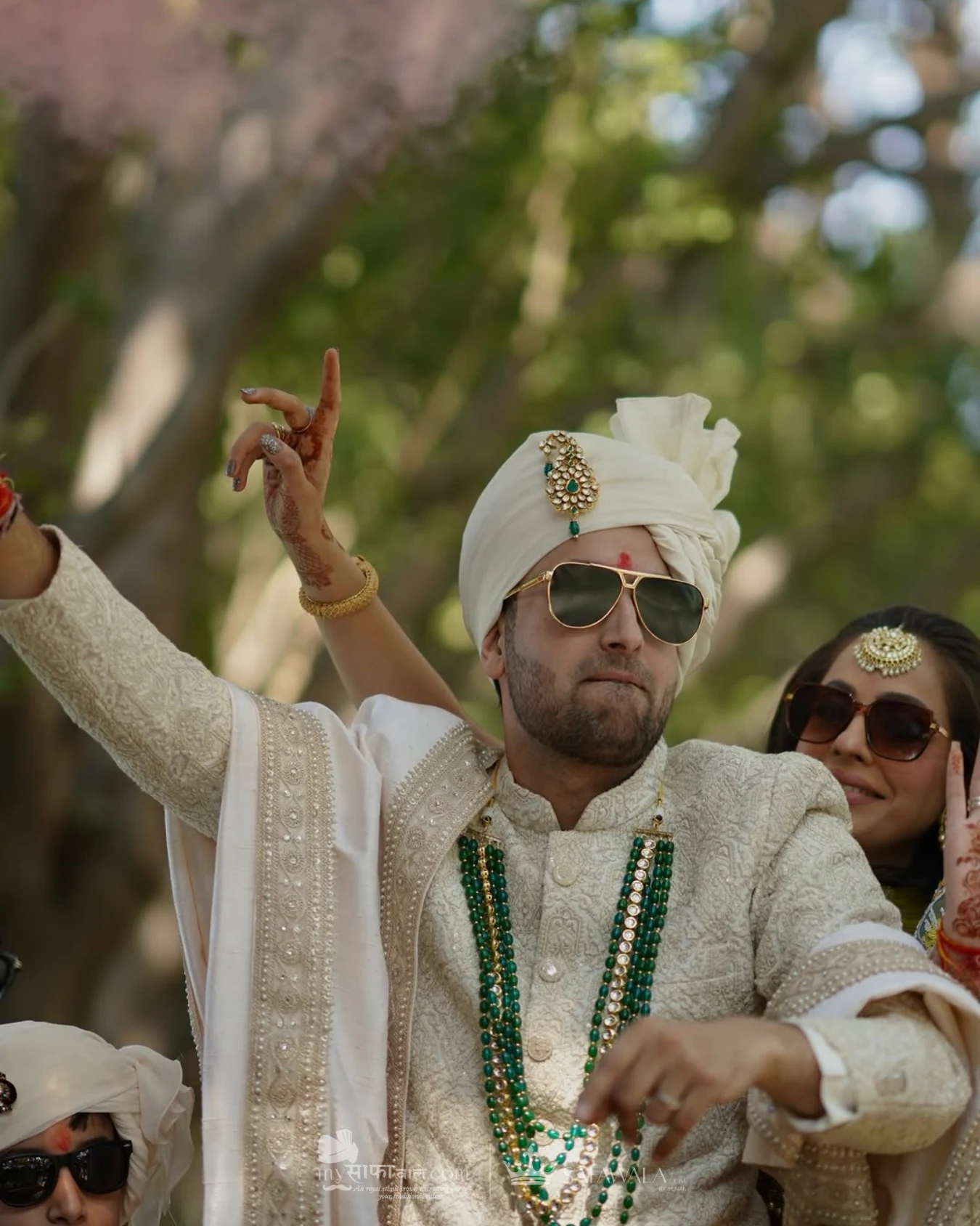 Groom in an ivory wedding safa with emerald jewellery for Bang Tao